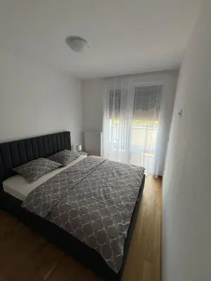 a bedroom with a bed and a window at Stan na dan Simba in Banja Luka