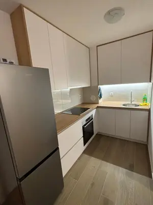 a kitchen with white cabinets and a stainless steel refrigerator at Stan na dan Simba in Banja Luka