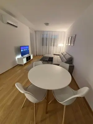 a living room with a white table and chairs at Stan na dan Simba in Banja Luka