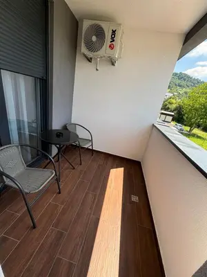 a balcony with a fan and a table and chairs at Stan na dan Simba in Banja Luka