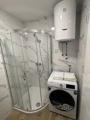 a bathroom with a shower and a toaster oven at Stan na dan Simba in Banja Luka