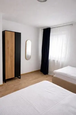a bedroom with two beds and a window at Apartmani Sun & Moon in Žepče