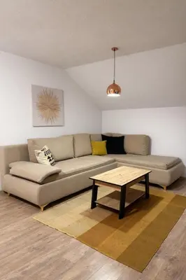 a living room with a couch and a coffee table at Apartmani Sun & Moon in Žepče