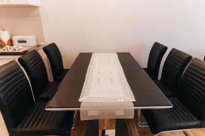 a dining room table with black chairs around it at Pronađi svoj mir in Livno