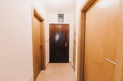 a hallway with a brown door in a room at Pronađi svoj mir in Livno