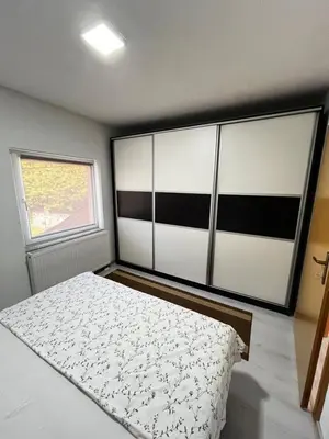 a bedroom with a bed and a window at Apartment M&S Gračanica in Gračanica