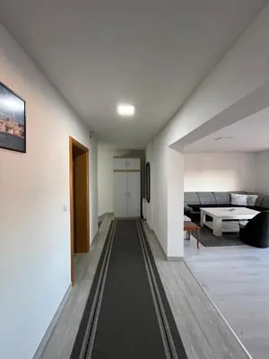 a hallway leading to a living room with a couch at Apartment M&S Gračanica in Gračanica