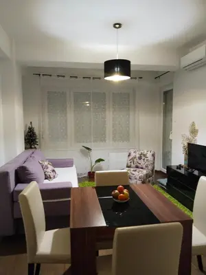 a living room with a table and a couch at Apartman IJA in Banja Luka