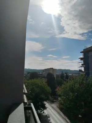 a view from a balcony of a city with the sun at Apartman IJA in Banja Luka