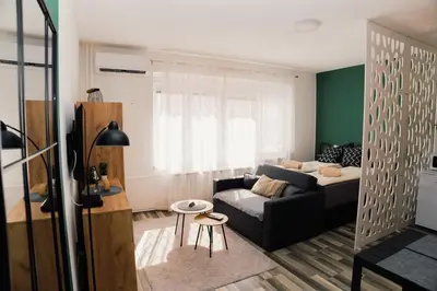 a living room with a couch and a table at Apartment Vela in Tuzla
