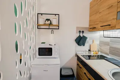 a kitchen with a white refrigerator and a sink at Apartment Vela in Tuzla
