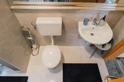 a bathroom with a toilet and a sink at Apartment Vela in Tuzla