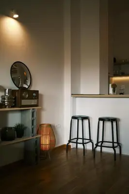 a room with two stools and a counter with a mirror at Ikigai Penthouse Apartment in Banja Luka