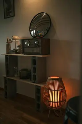 a table with a mirror and a lamp and a lampost at Ikigai Penthouse Apartment in Banja Luka