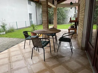 a patio with a table and chairs on a patio at Studio apartman Bišće in Bihać