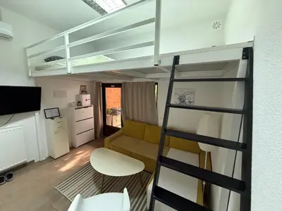 a living room with a bunk bed and a couch at Studio apartman Bišće in Bihać