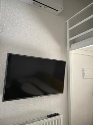 a flat screen tv hanging on a wall at Studio apartman Bišće in Bihać