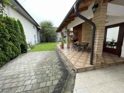 a patio of a house with a table and chairs at Studio apartman Bišće in Bihać