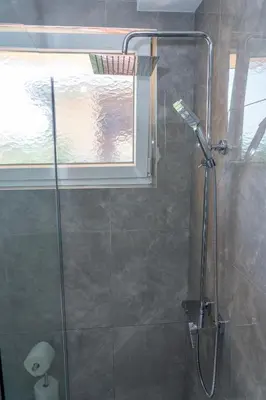 a shower with a glass door in a bathroom at Apartman Kruna in Drvar
