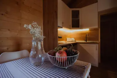 a bowl of fruit sitting on a table with a vase at Rustic Casa in Prijedor