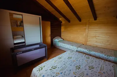 a bedroom with a bed and a dresser and a mirror at Rustic Casa in Prijedor