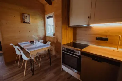 a small kitchen with a table and a stove at Rustic Casa in Prijedor