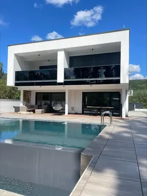 a large white house with a swimming pool at Villa Modern in Bihać