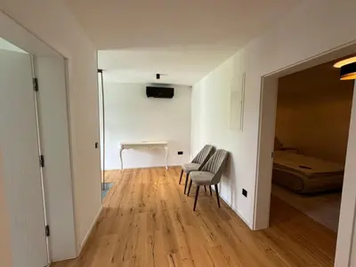 a hallway with two chairs and a table in a room at Villa Modern in Bihać