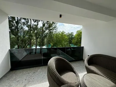 a living room with two chairs and a large window at Villa Modern in Bihać