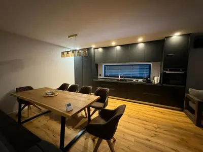a living room with a dining room table and chairs at Villa Modern in Bihać