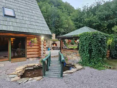 a house with a wooden staircase leading to a porch at Villa Bosnia in Donji Vakuf