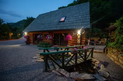 a log cabin with a bench in front of it at Villa Bosnia in Donji Vakuf