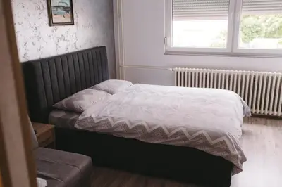 a small bed in a bedroom with a window at Apartmani Vesto in Banja Luka