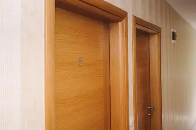 a wooden door with a handle in a room at Apartmani Vesto in Banja Luka