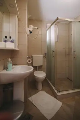 a bathroom with a toilet and a sink and a shower at Apartmani Vesto in Banja Luka