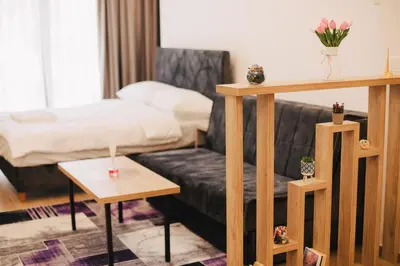 a living room with a couch and a bed at KS Apartments in Visoko