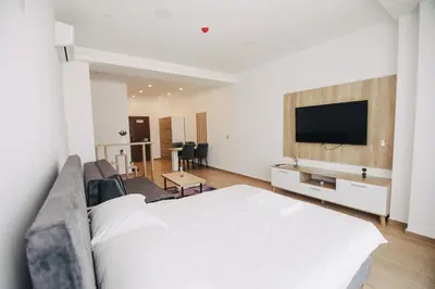 a bedroom with a bed and a flat screen tv at KS Apartments in Visoko