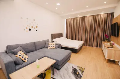 a living room with a couch and a bed at KS Apartments in Visoko