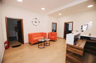 a living room with an orange couch and a table at KS Apartments in Visoko