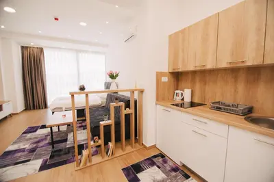 a kitchen with a table and a kitchenasteryasteryasteryasteryasteryasteryasteryastery at KS Apartments in Visoko