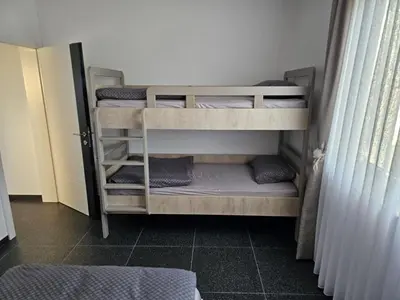 a room with three bunk beds in a room at Villa AS in Bihać