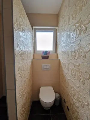 a small bathroom with a toilet and a window at Villa AS in Bihać