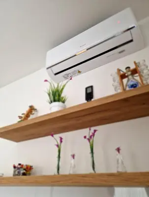 a wooden shelf with flowers in vases on it at Villa AS in Bihać