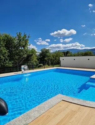 a large swimming pool with blue water at Villa AS in Bihać