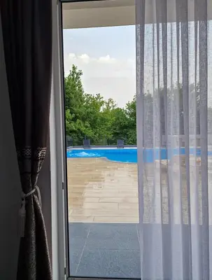 a sliding glass door with a view of a pool at Villa AS in Bihać