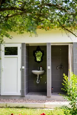 a bathroom with a sink and a shower at Moonlight & Starlight lodges in Orašac