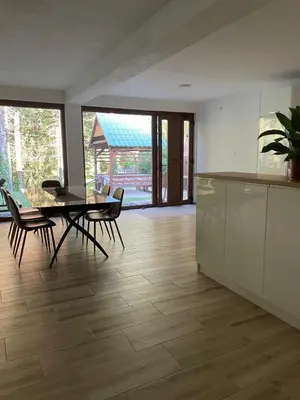 a kitchen and dining room with a table and chairs at Villa Bella Una - Prizemlje in Cazin