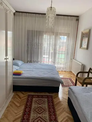 a bedroom with a bed and a chandelier at Apartment Alma in Bihać