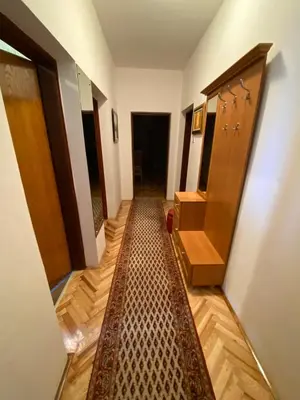 a hallway with a rug in the middle of a room at Apartment Alma in Bihać