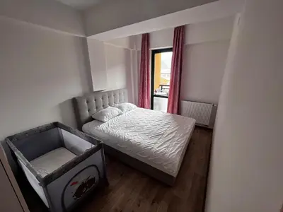 a small bedroom with a bed and a window at Apartman Rita in Fojnica
